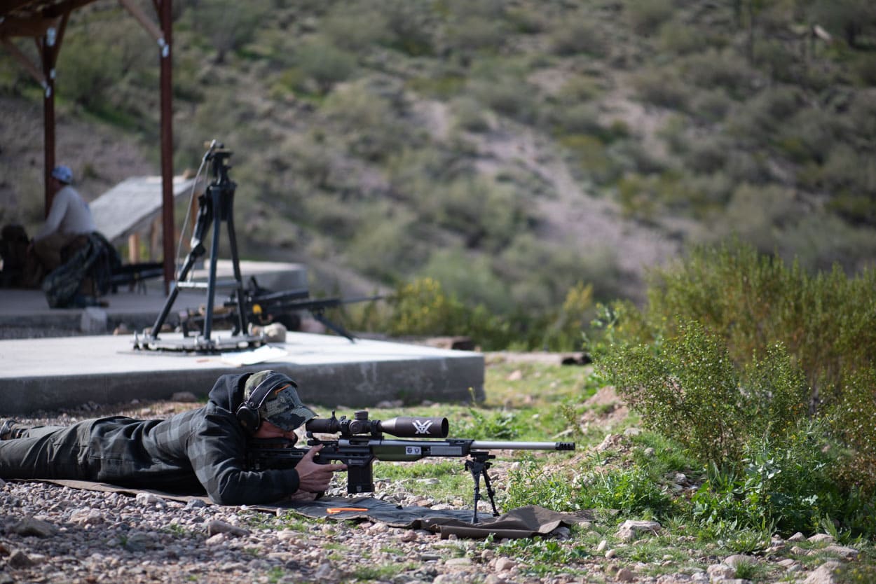 A shooter utilizes a specialized long-range system on a 1,000-yard platform, focusing on technical accuracy and ballistics in the desert environment.