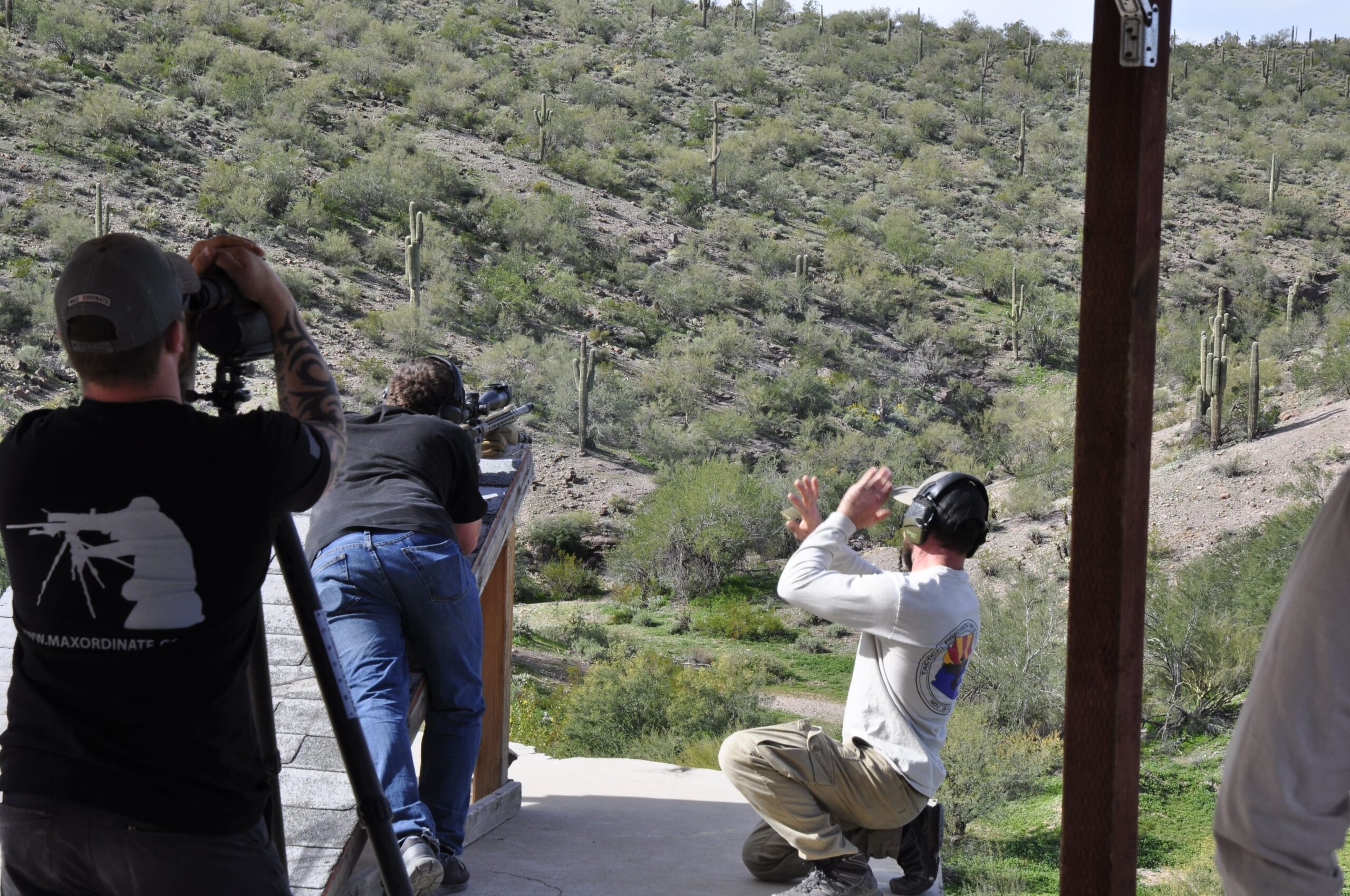 Serious practitioners on an elevated long-range platform reading the mirage and engaging targets across the Arizona desert.