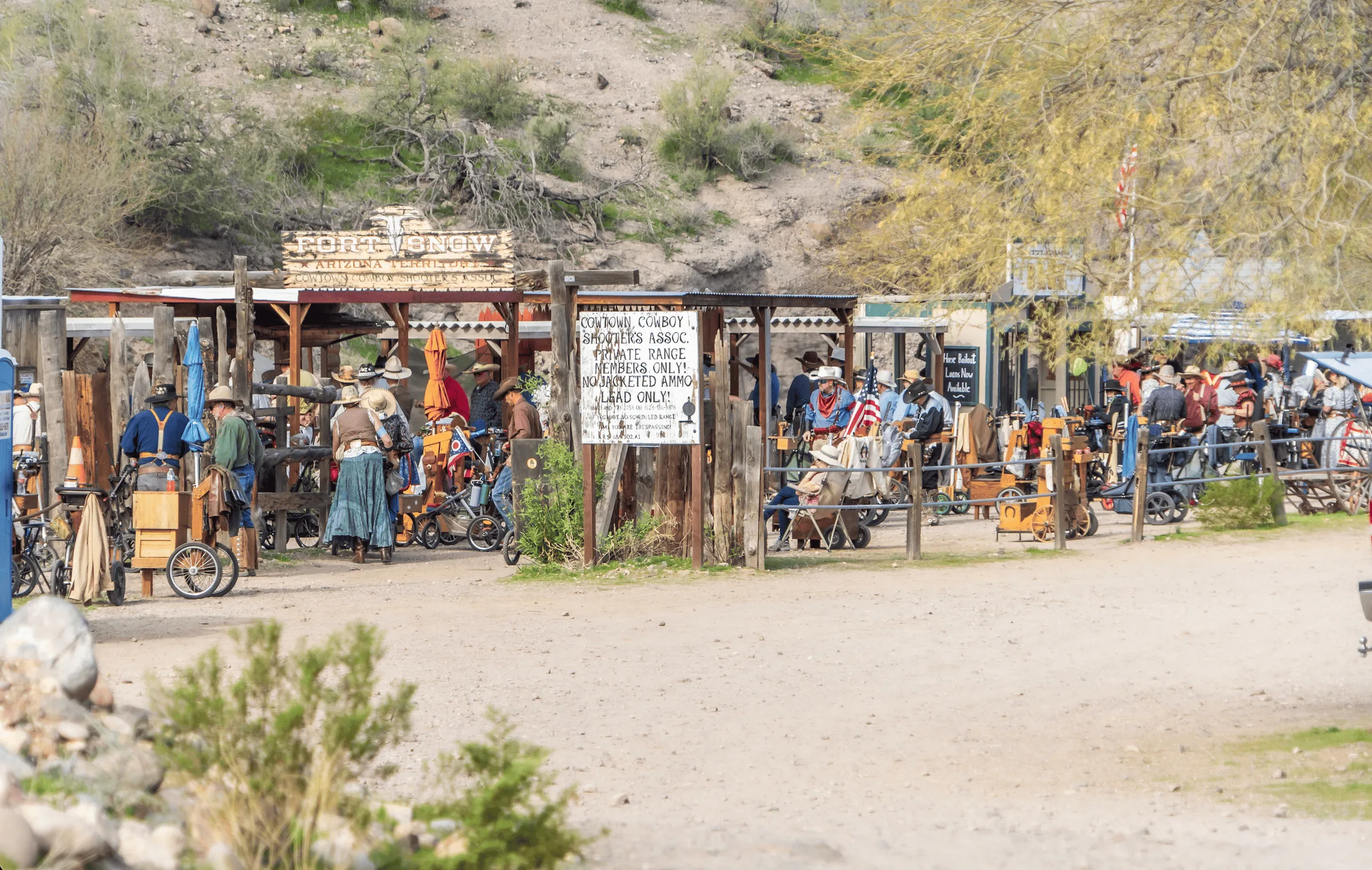 Shooters in historical Western attire gathered at Fort Snow stage on the dusty desert grounds of Cowtown Range.