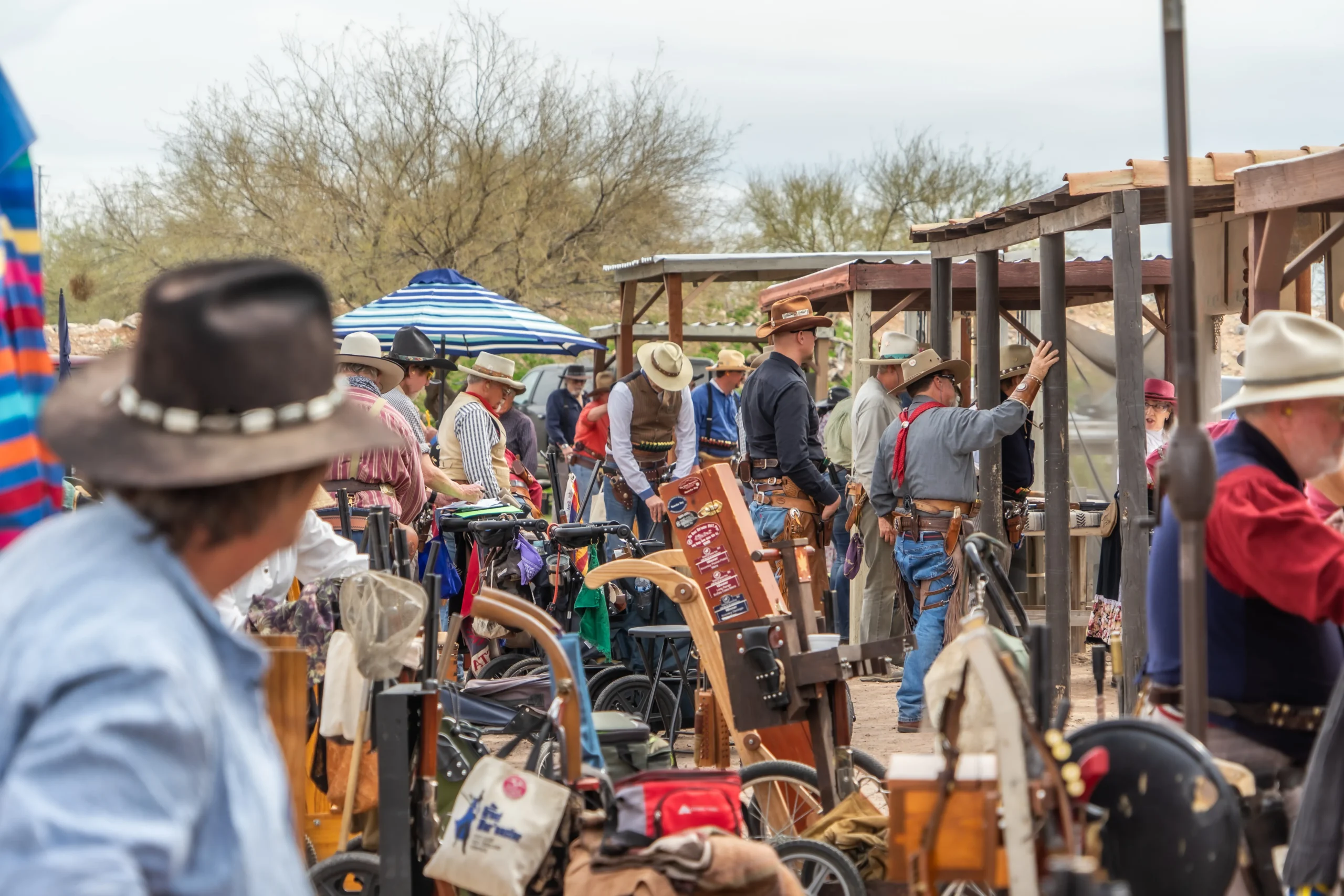 SASS competitors gathered with their gear carts at Cowtown Range during a Cowboy Action Shooting match.